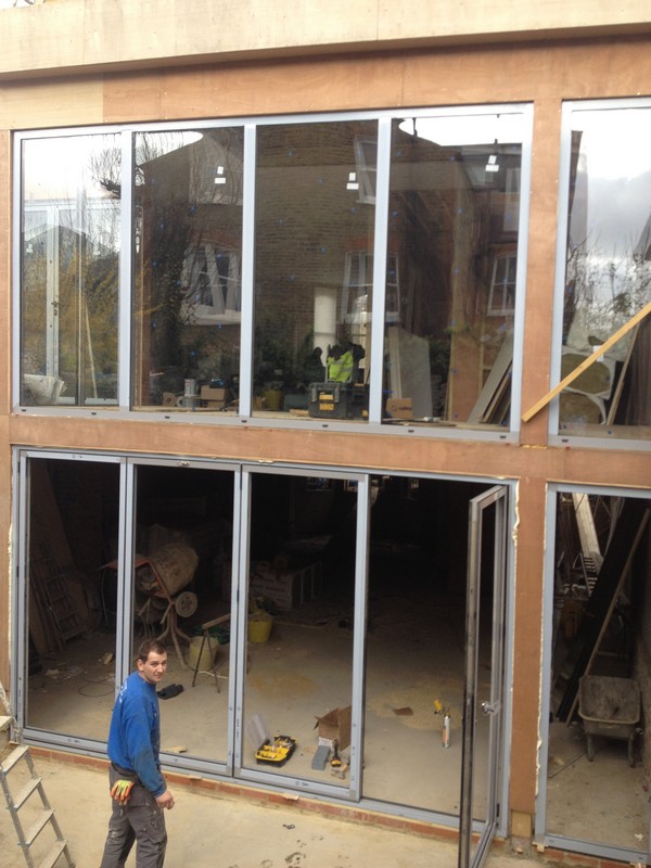 Aluminium bi-fold doors with two-storey glazing in Northwood