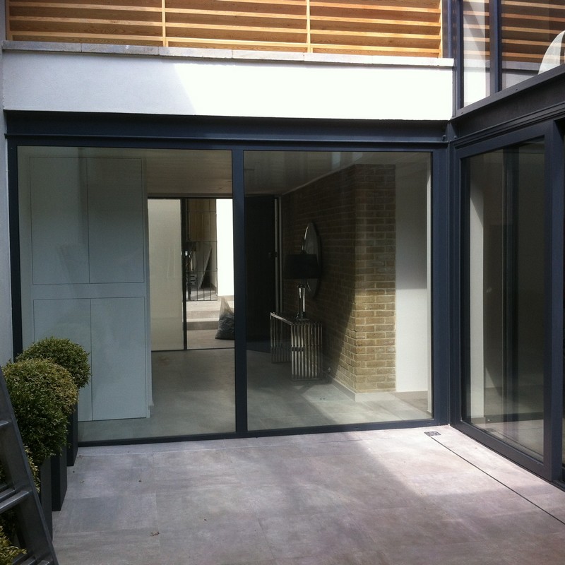 Floor-to-ceiling sliding doors opening to courtyard in Northwood