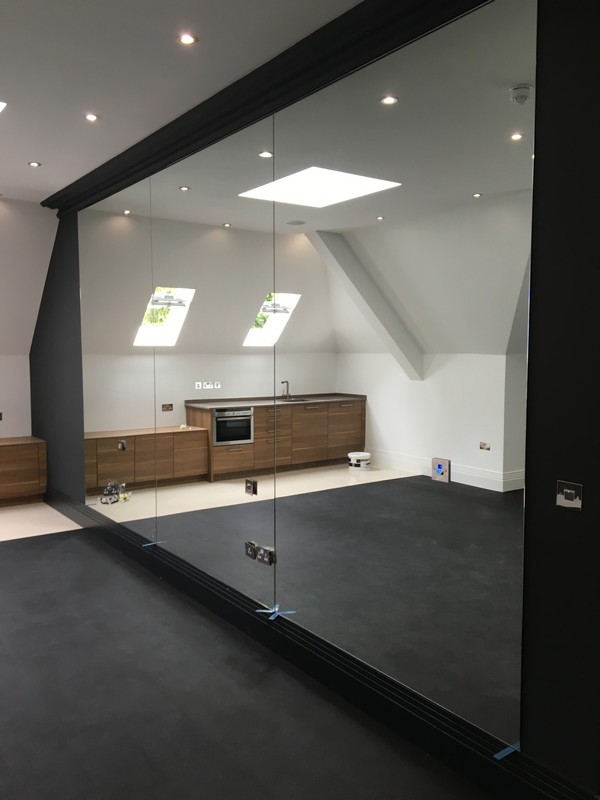 Frameless glass partition in loft conversion by Northwood glaziers