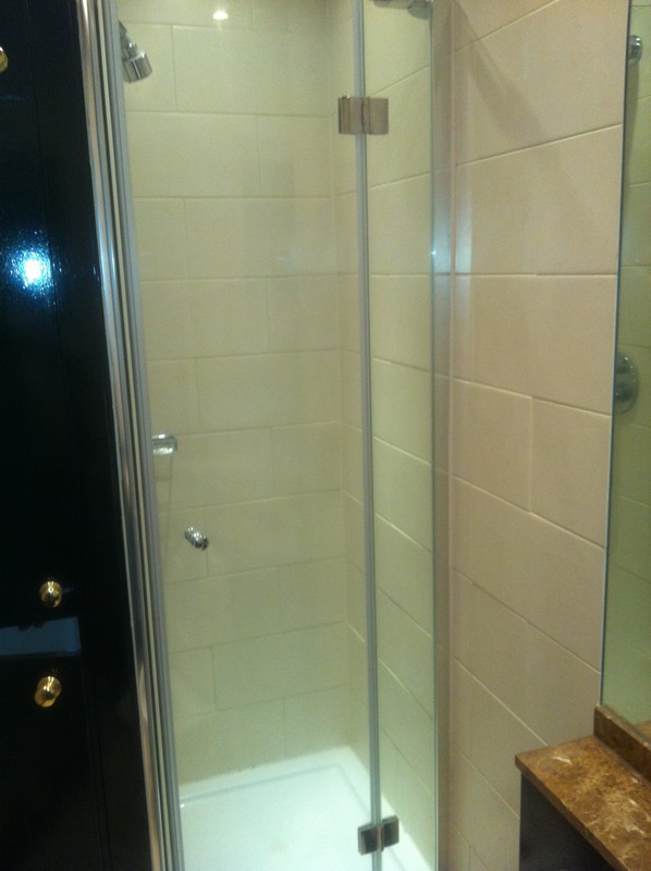 Frameless glass shower enclosure with chrome fittings in Northwood