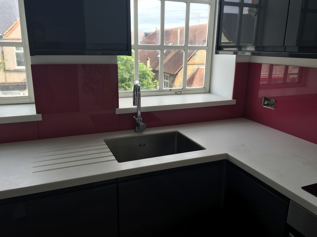 Deep plum coloured glass splashback in modern Northwood kitchen